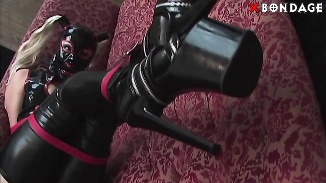 RubberAndBondage - Latexed Blondie Struggles Restricted Within Leather Belts