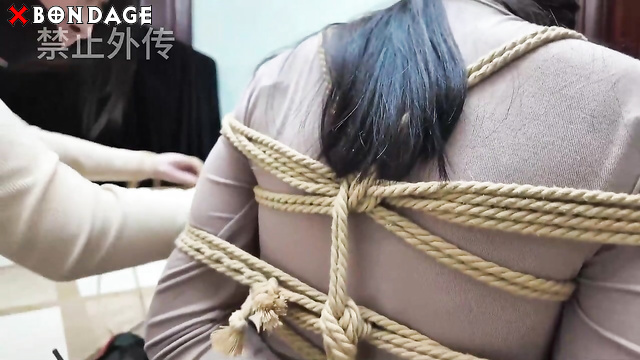 Chinese Bondage - Two Asian Brunettes Tightly Bound within Tape and Rope