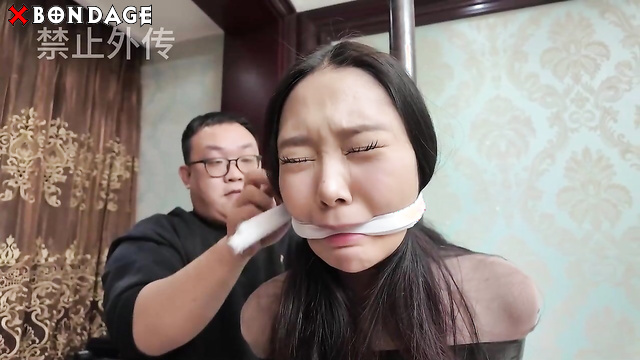 Chinese Bondage - Two Asian Brunettes Tightly Bound within Tape and Rope