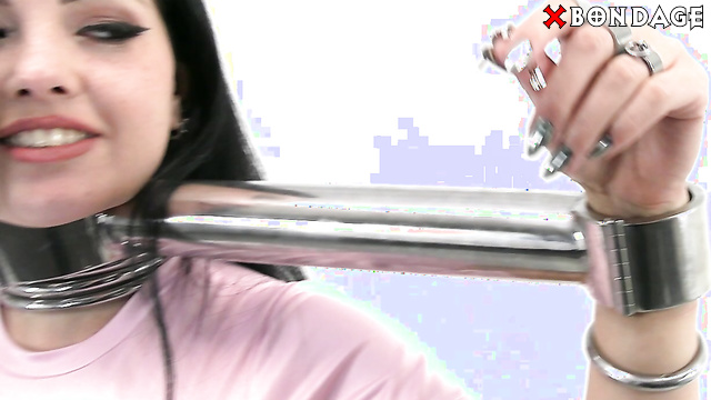 MetalBondage - Sexy Big Tits Brunette Smiles in a Rigidstock