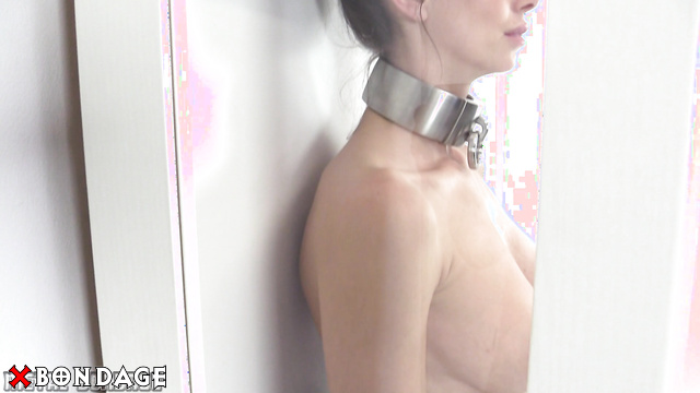 MetalBondage - Sexy Naked Brunette Shackled in a Showcase