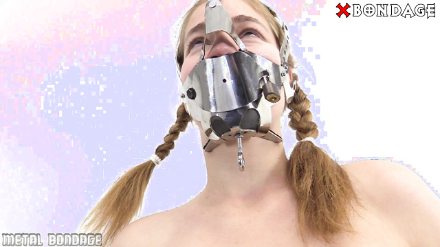 MetalBondage - Naked Skinny Redhead Struggles in an Iron Mask