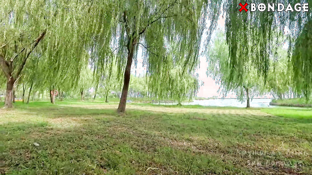 Raymond Moves Carefully Outdoors, Her Thighs Restrained Beneath Her Skirt